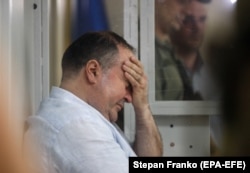 Borys Herman, accused by authorities of hiring someone to assassinate Babchenko, reacts in a Kyiv courtroom on May 31.