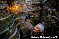 A man lays flowers at a memorial to Soviet soldiers killed during the Soviet war in Afghanistan in Minsk in February 2018.