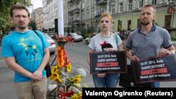 People attend a ceremony to mark the death anniversary of journalist Pavel Sheremet in Kyiv on July 20.