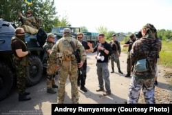 Director Oleg Dzhurayev, with the bullhorn, instructing actors on the set of "The Truth."