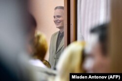 Christensen stands inside the defendants' cage as he awaits the verdict.