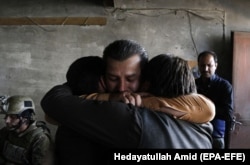 The staff of Shamshad TV react after they were rescued by security forces following an attack by Islamic State militants at the station in Kabul on November 7. A security guard was killed in the attack.