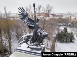 A figure carrying a torch of freedom atop the mausoleum of Lajos Kossuth in Kerepesi Cemetery