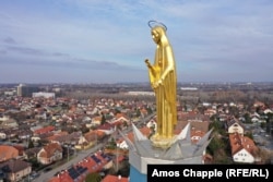 A golden statue of Mary stands atop a church spire in southern Budapest.