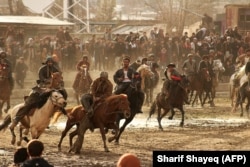 Horsemen compete during a game of the buzkashi in the northeastern Afghan city of Badakhshan in February 2018.