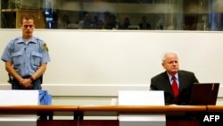 The late Yugoslav ex-President Slobodan Milosevic (right) on trial at The Hague in 2004