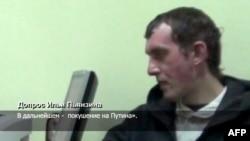 Russian Channel 1 TV grab shows a man identified as Ilya Pyanzin, one of those suspected of conspiring to kill Vladimir Putin, during interrogation with agents of the Ukrainian Security Service.