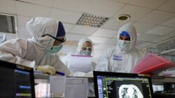 Iranian medical personnel wearing protective gear work at the quarantine ward of a hospital in Tehran on March 1.