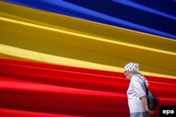 An elderly woman stands in downtown Chisinau. (file photo)