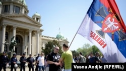 Supporters of right-wing movements shout slogans such as "Kosovo Is Serbia" in front of the National Assembly in Belgrade on April 26.