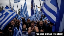 Protesters wave Greek national flags and shout slogans during a rally against the use of the term "Macedonia" in Athens on February 4.