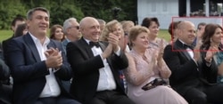 Eduard Bendersky (far right) is shown applauding at the wedding of his daughter, Alyona, to Maksim Yakubets, whom U.S. prosecutors accuse of a massive cybertheft.