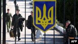 Ukrainian pilots leave the Belbek air base outside Sevastopol on March 21. Remaining troops now face a Russian ultimatum.