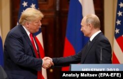 U.S. President Donald Trump (left) and Russian President Vladimir Putin shake hands at their meeting in Helsinki in July.