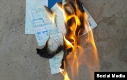 Artyom is shown first stepping on the passport and then burning it.