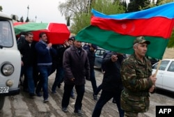 Men carry the coffin of an Azerbaijani serviceman who was killed on April 2 during clashes between ethnic Armenian and Azerbaijani forces in Nagorno-Karabakh.