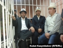 Kamchybek Tashiev (left to right), Sadyr Japarov and Talant Mamytov prepare to stand trial in Bishkek in 2013.