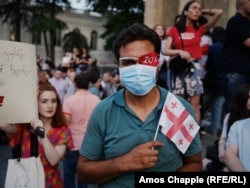 A crowd numbering in the low thousands gathered for another evening of protests outside Georgia's parliament building on June 22, 2019. One sported an eyepatch marked "20%," a reference to the injuries sustained by protesters over previous days as well as the amount of Georgian territory made up by Abkhazia and South Ossetia.