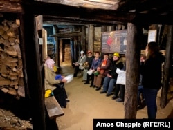 Bosnian tourists sit inside the tunnel network in Visoko where Djokovic went to meditate. A local expert told AFP the tunnels are probably the remnants of a disused gold mine.