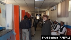 Abdul Hadi, pictured in the middle, lodges a complaint at Breshna Sherkat over his electricity bill.