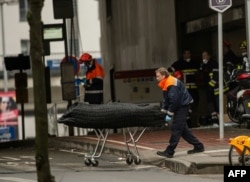 Medical personnel remove the body of a victim from the Maalbeek subway station on March 23, a day after the attacks.