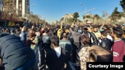 Iranians take to the streets of Mashhad on December 29 in one of several demonstrations in the country against increasingly high prices and other economic woes.