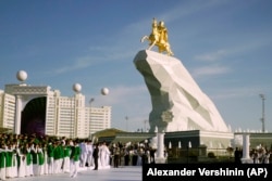 People gather for the unveiling ceremony in Ashgabat in May 2015 of Gurbanguly Berdymukhammedov's tribute to himself.