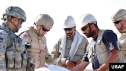 U.S. and Afghan engineers review blueprints for an Afghan National Army garrison in Farah Province. (file photo)