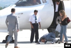 Ljube Boskovski kisses the tarmac as he returns to Macedonia from The Hague in September 2008.