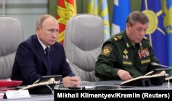 Russian President Vladimir Putin (left) and General Valery Gerasimov hand out warnings to the West with sometimes astonishing regularity.