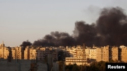 Heavy smoke covers the skyline of Aleppo after a bombing run by Syrian aircraft on September 24.