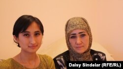 Gulnoza and her mother, Azadajon, work together selling perfumes at a stand at the bazaar in Osh.