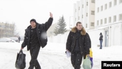 Two men arrested at the December 19 demonstration are released from a detention center in Minsk last week. But will they now face the loss of their job or university position?