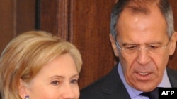 Russian Foreign Minister Sergei Lavrov speaks with U.S. Secretary of State Hillary Clinton in Moscow on October 13.