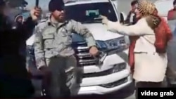 Afghan parliamentary deputy Parwin Durrani confronts a police officer in Kabul on March 7, moments before she slapped him.