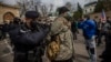 Police detain a protester as people gather in front of the Russian Embassy in Prague on April 18.