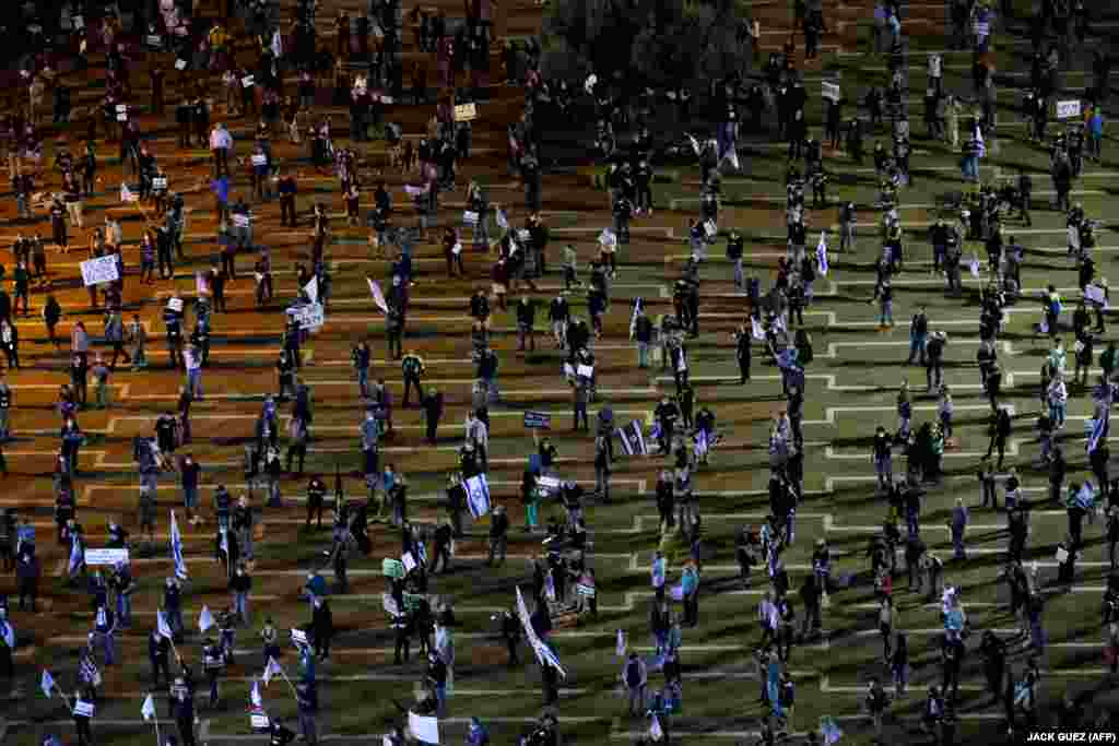 Protesters in Tel Aviv take part in a &quot;Black Flag&quot; demonstration to protest against Israeli Prime Minister Benjamin Netanyahu and measures to contain the coronavirus outbreak.