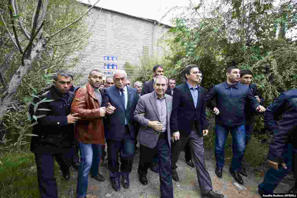 Hasanli (center) has used his campaign to criticize widespread corruption in the Aliyev government, and has actively sought to meet with supporters in Azerbaijan's smaller towns and regions. Here, Hasanli prepares for a speech in the city of Sumgait on October 6. 