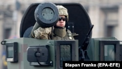 A Ukrainian soldier rides with a Javelin antitank missile in a Kyiv parade in August 2018.