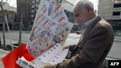 A man reads a campaign pamphlet in central Tehran ahead of Iran's 2012 parliamentary elections.