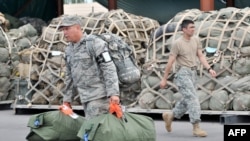 U.S. soldiers before boarding a plane to Afghanistan from the U.S. transit center at Manas.