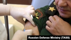 Russian Defense Minister Sergei Shoigu receiving the Sputnik V coronavirus vaccine in Moscow on September 4.