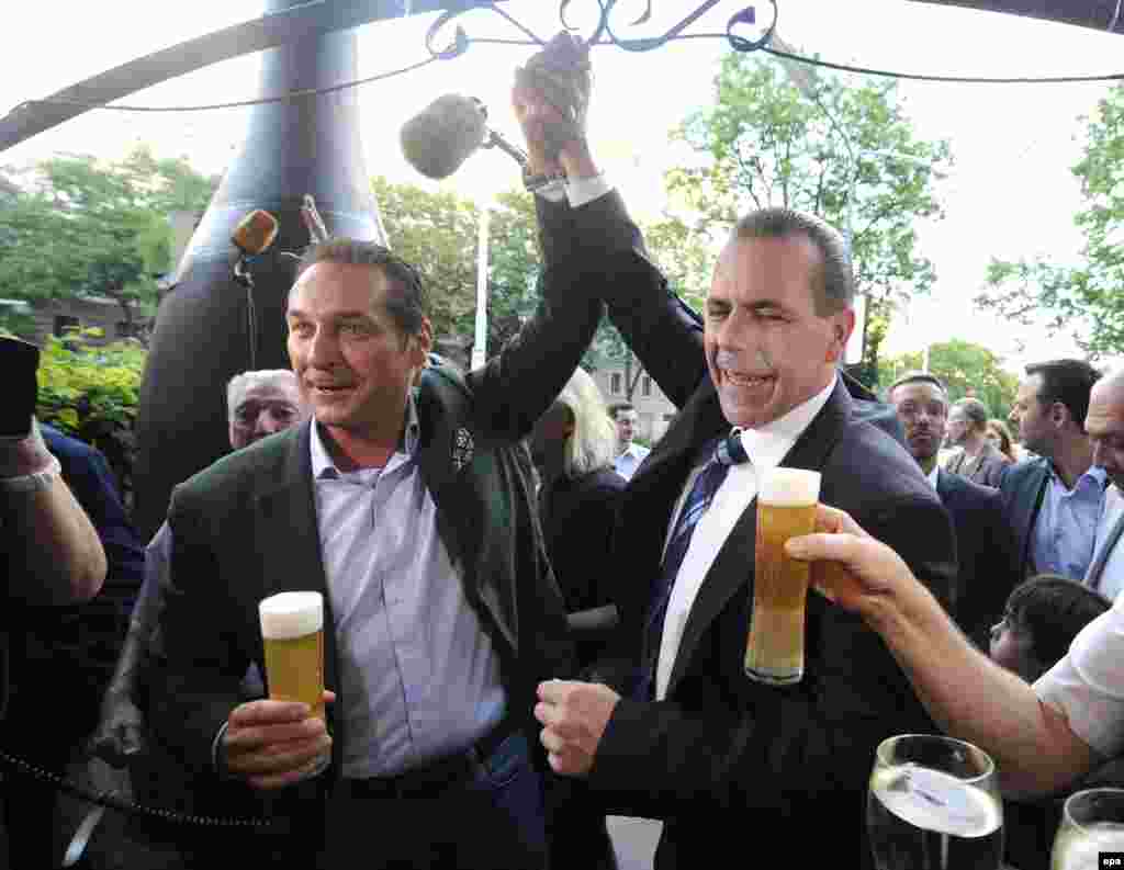 The head of the far-right Freedom Party of Austria, Heinz-Christian Strache (left), and fellow candidate Harald Vilimsky celebrate the preliminary results, which showed their party with some 20 percent of Austria&#39;s vote.