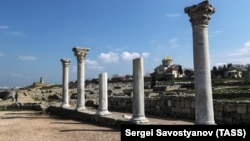 The ruins of an ancient basilica (foreground) and the St. Vladimir Cathedral (background) are seen at the Tauric Chersonesos preserve in Sevastopol in 2017.