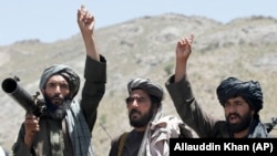 Taliban fighters react to a speech by their senior leader in the Shindand district of Herat Province in May 2016.