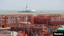 An oil rig (rear) and infrastructure of D Island, the main processing hub, are pictured at the Qashaghan offshore oil field in the Caspian Sea.