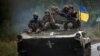 Ukrainian soldiers ride a BMP-1 infantry fighting vehicle near the recently liberated town of Izyum, on September 14.