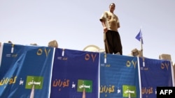 A wall draped with election posters in the northern Iraqi city of Sulaimaniyah.