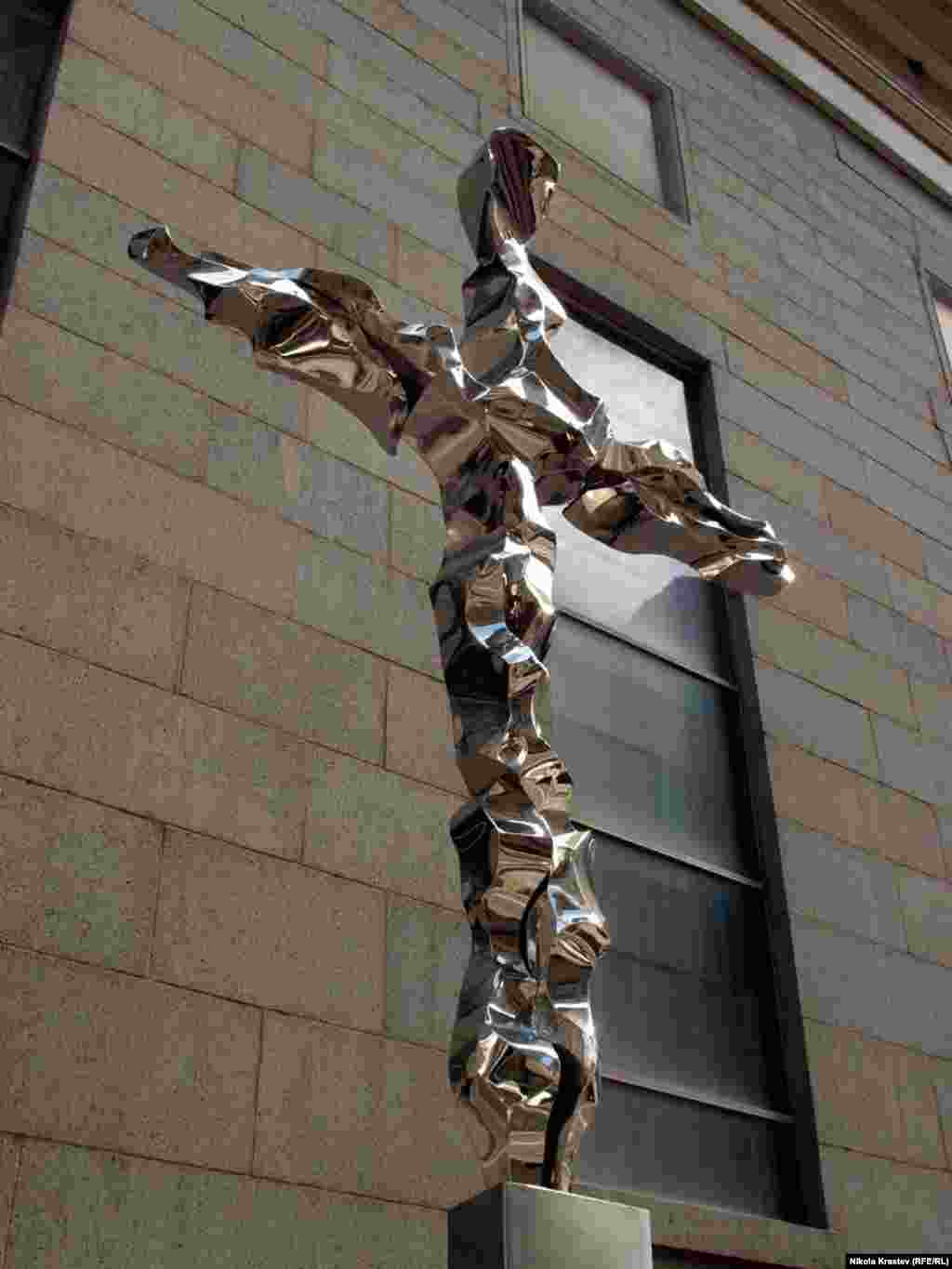 This memorial cross is made of distressed metal collected from the site.