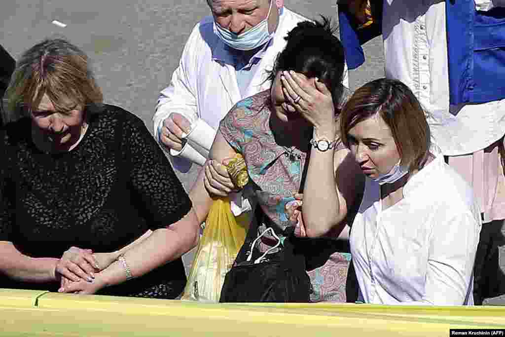 A woman cries as she is taken to an ambulance at the scene of the shooting at School No. 175 in Kazan.